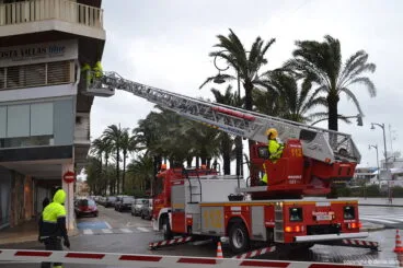 Bomberos retirando un cartel