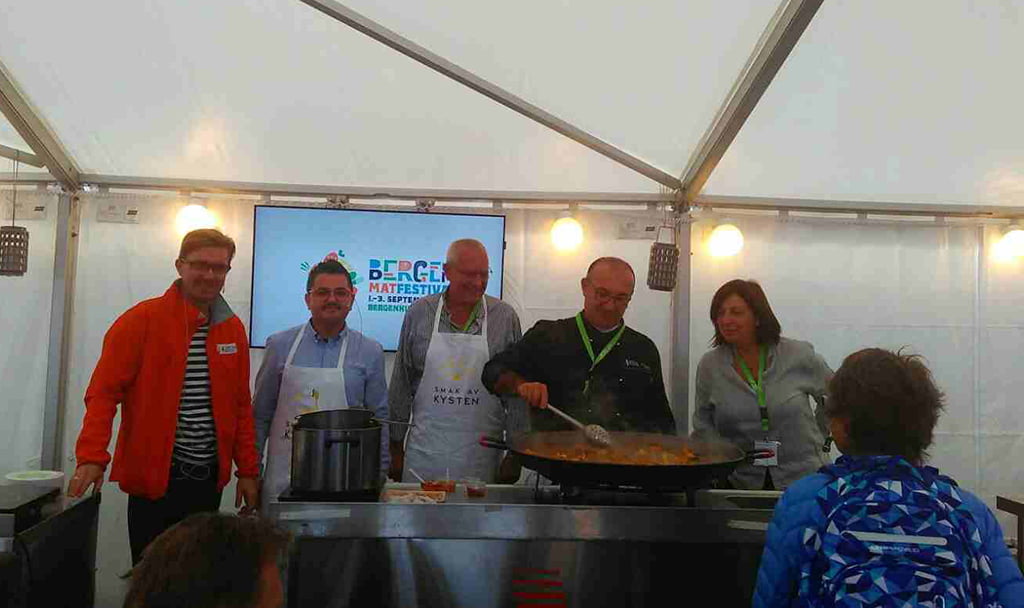 Representantes dianense en la Feria de Bergen cocinando una paella
