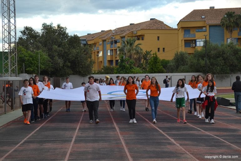 Voluntarios llevando la bandera olímpica