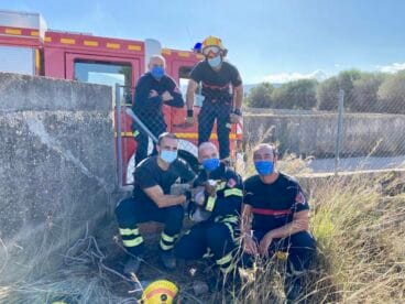 bomberos junto a la cabra rescatada