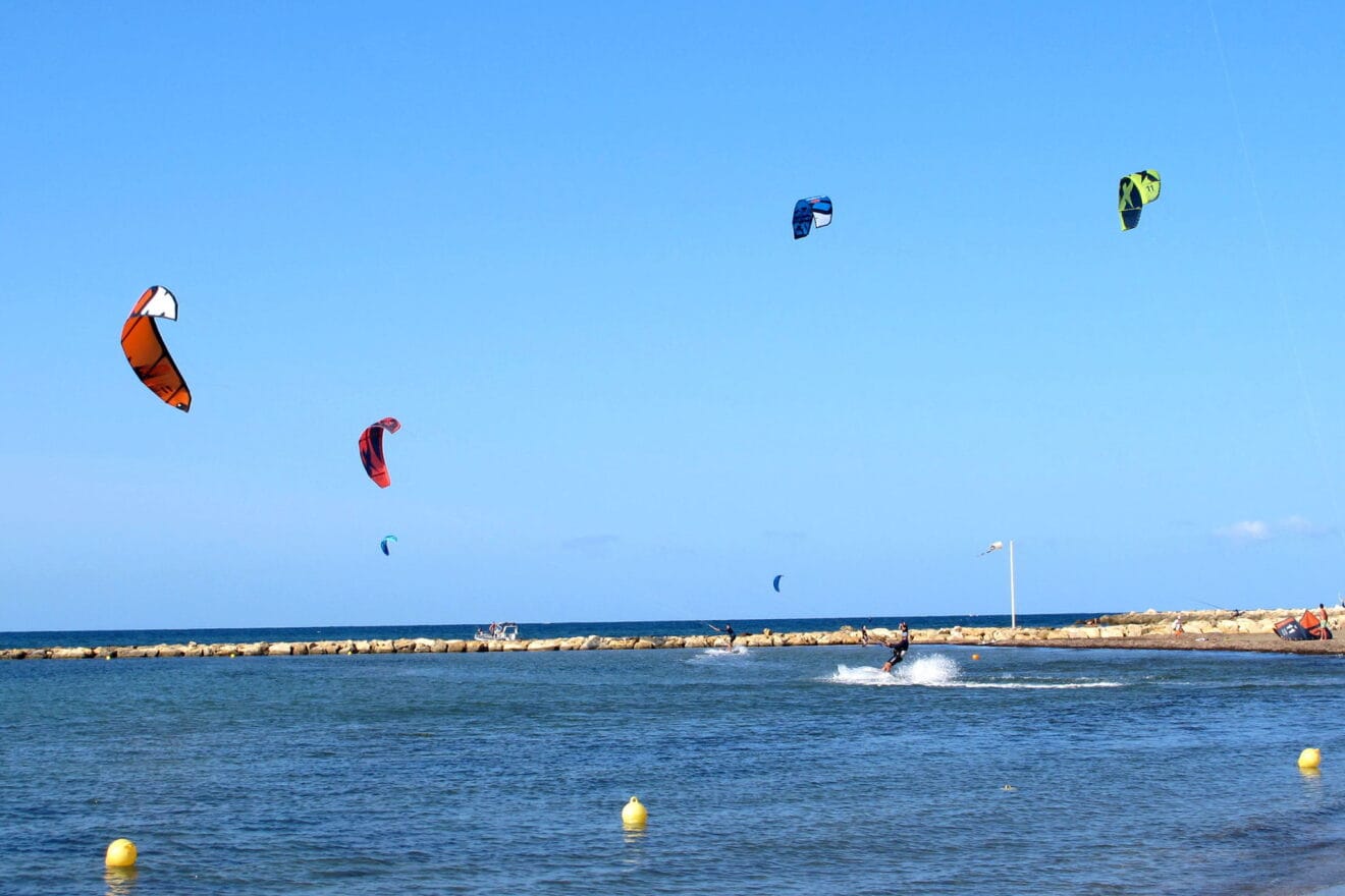 Bañistas practicando kite surf en la zona habilitada de El Raset