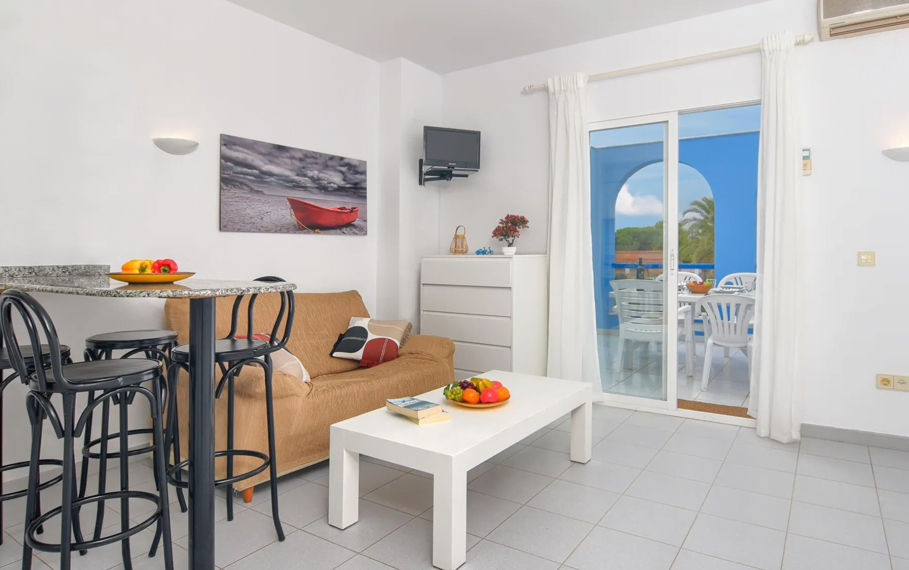 Salón-comedor con acceso a la terraza de este apartamento de Dénia disponible con Aguila Rent a Villa