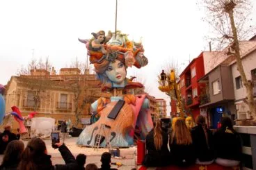 Falleros y falleras de la Oeste presenciando la colocación de su monumento central
