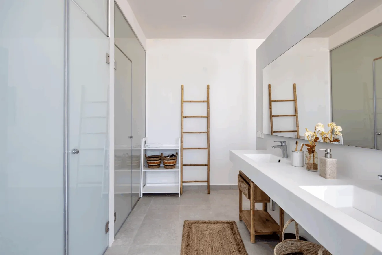 Baño del dormitorio principal con ducha y dos lavabos