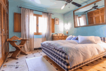 Dormitorio rústico de la vivienda con armario empotrado