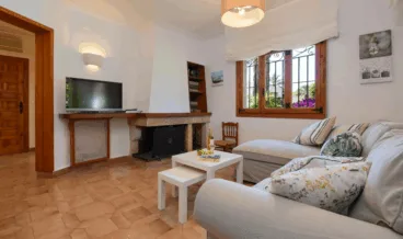 Salón de la vivienda con chimenea y televisión