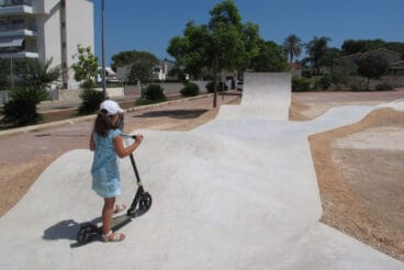 Niña con un patinete en el pump track de Dénia