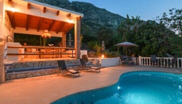 Piscina privada iluminada durante una noche de verano