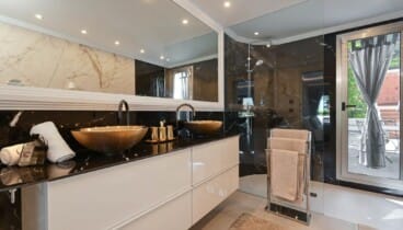 Baño de lujo y espacioso con acabados marmolados