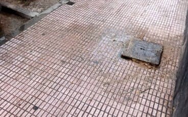 estado de la acera afectada en la zona de la falla paris pedrera con los restos de los vertidos extendidos por el suelo